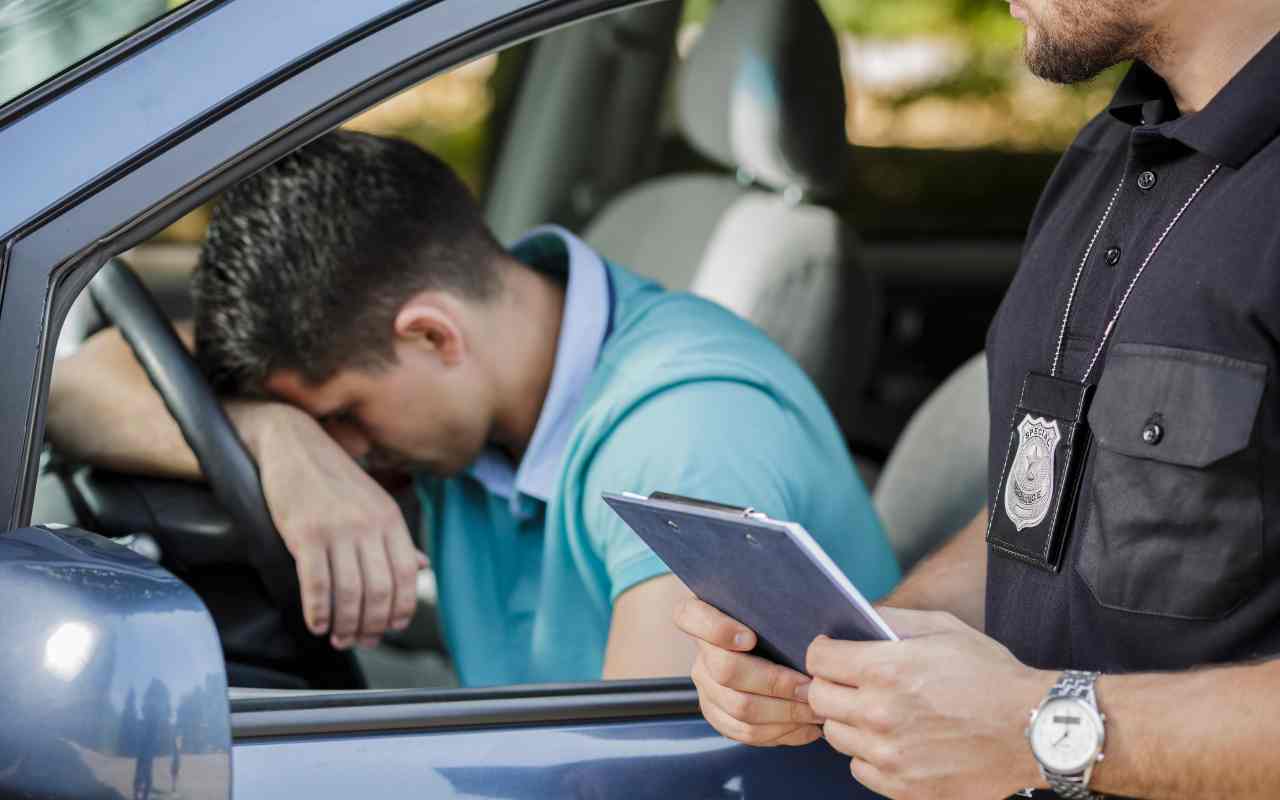 Uomo viene multato in auto (AdobeStock)